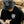 Person wearing the Stay Wild bucket hat and matching black t-shirt, both featuring the white panther logo and bold lettering