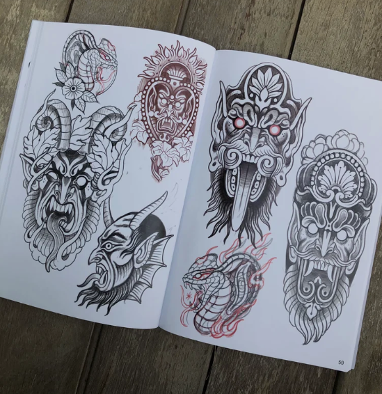 Open spread of the CHANKEOS Sketchbook showing detailed ink-style tattoo drawings of demons, masks, and mythological beasts in black and red tones